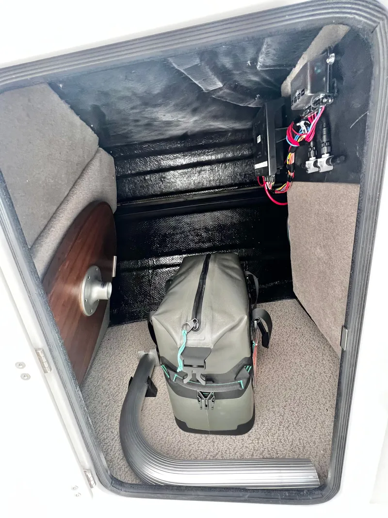 Slide: The Image of Stingray 211DC storage compartment with bag and cables, 2026 model. - 26