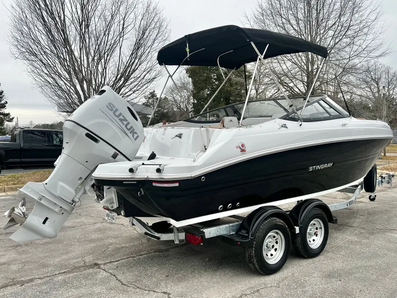 Slide: The Image of 2026 Stingray 211DC boat with Suzuki engine, on trailer. - 5
