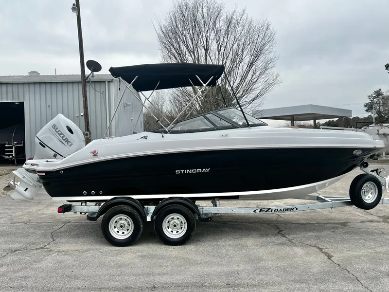 Slide: The Image of 2026 Stingray 211DC boat on trailer, Suzuki engine. - 6