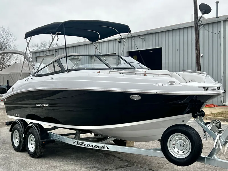 Slide: The Image of 2026 Stingray 211DC boat on trailer, in stock, $74,749. - 7