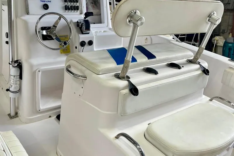 Slide: The Image of 2001 Pro-Line 25 Sport CC boat interior with steering wheel and seating. - 13