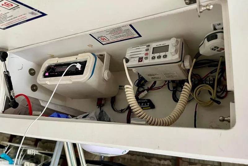 Slide: The Image of 2001 Pro-Line 25 Sport CC boat electronics compartment with radio and wiring. - 15