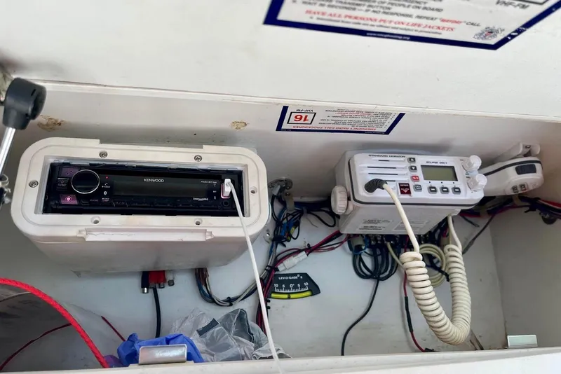 Slide: The Image of 2001 Pro-Line 25 Sport CC boat electronics, featuring Kenwood stereo and marine radio system. - 16