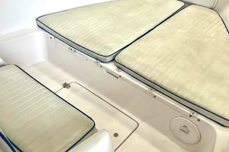 Slide: The Image of 2001 Pro-Line 25 Sport CC boat interior with cushioned seating. - 18