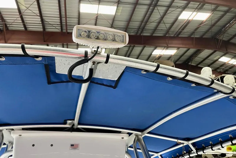 Slide: The Image of 2001 Pro-Line 25 Sport CC boat with blue canopy and mounted light. - 19