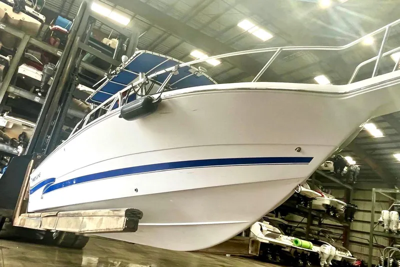 Slide: The Image of 2001 Pro-Line 25 Sport CC boat in storage facility, elevated by forklift. - 2