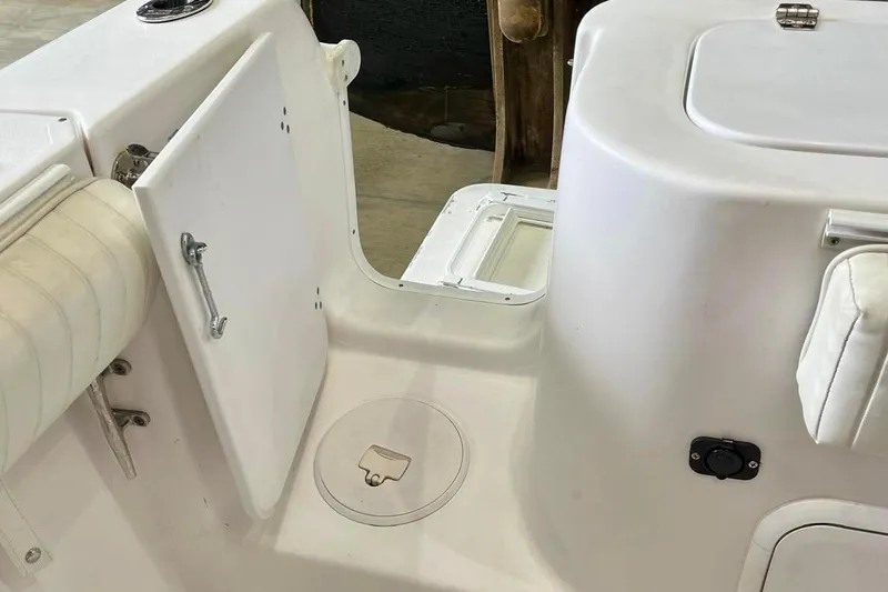 Slide: The Image of 2001 Pro-Line 25 Sport CC boat interior, featuring storage compartments and seating. - 21