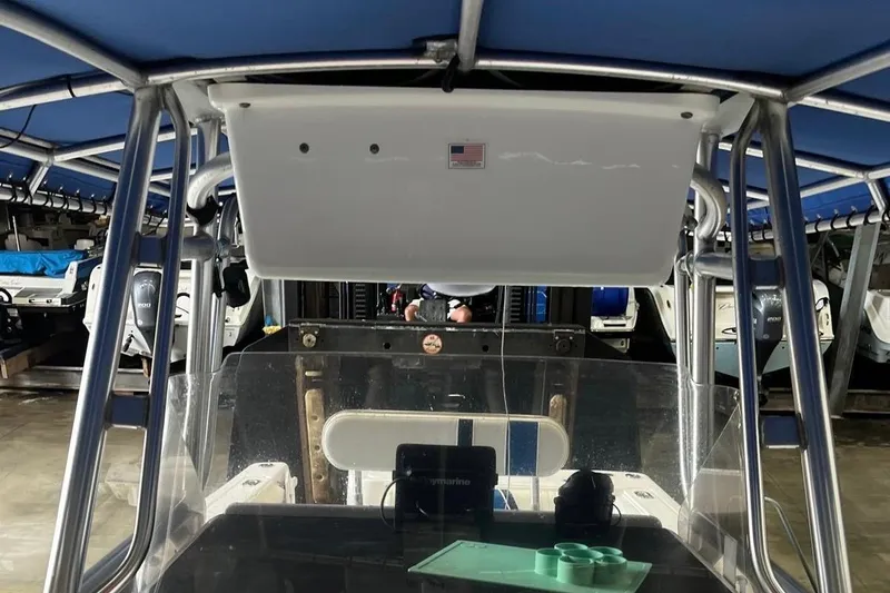 Slide: The Image of 2001 Pro-Line 25 Sport CC boat interior with canopy and control panel. - 22