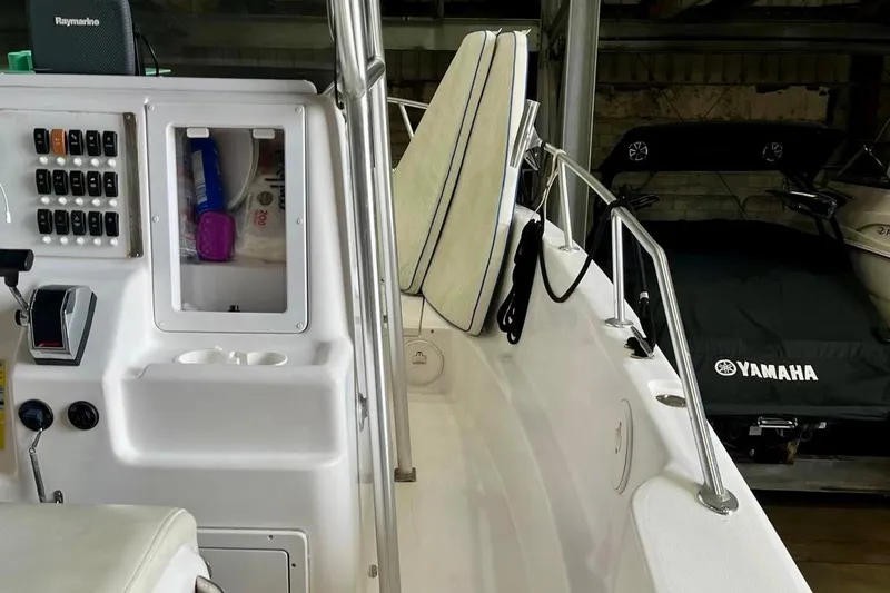 Slide: The Image of 2001 Pro-Line 25 Sport CC boat interior with control panel and seating. - 23