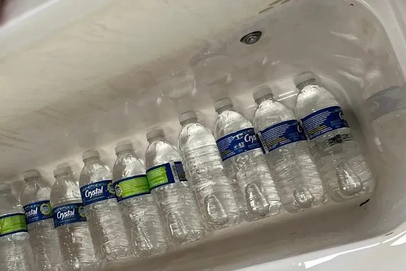 Slide: The Image of Bottled water stored in a cooler on a 2001 Pro-Line 25 Sport CC boat. - 25