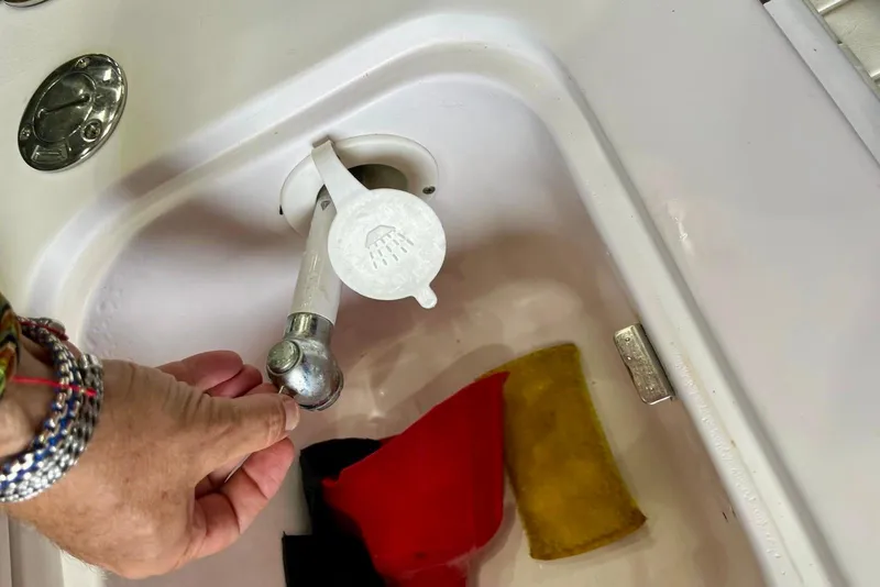 Slide: The Image of Hand operating faucet on 2001 Pro-Line 25 Sport CC boat sink. - 26