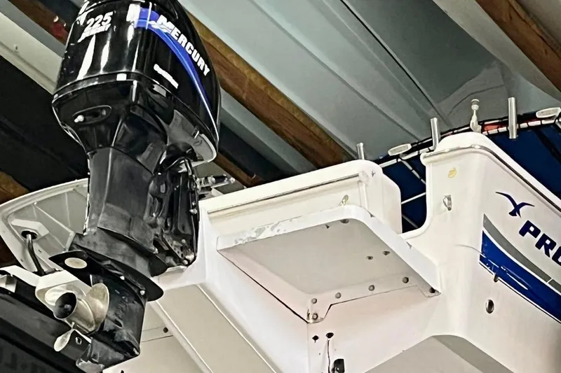 Slide: The Image of 2001 Pro-Line 25 Sport CC boat with Mercury 225 outboard motor in a storage facility. - 27