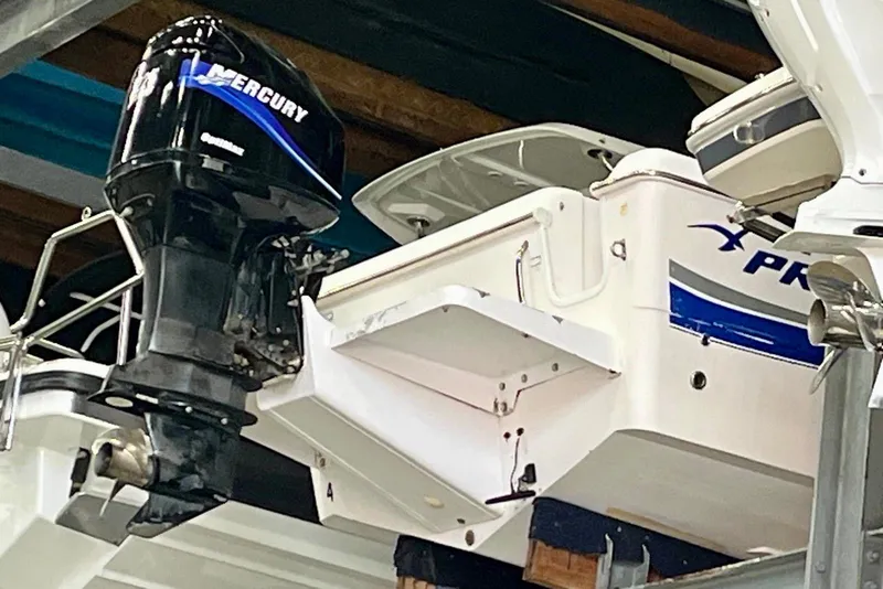 Slide: The Image of 2001 Pro-Line 25 Sport CC boat with Mercury outboard motor in storage. - 28