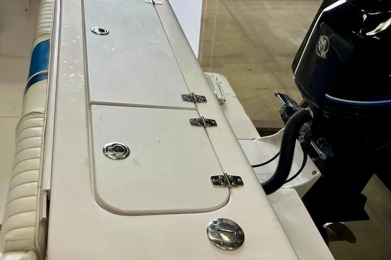 Slide: The Image of 2001 Pro-Line 25 Sport CC boat deck with storage compartments and outboard motor. - 29