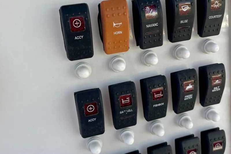 Slide: The Image of Control panel of a 2001 Pro-Line 25 Sport CC boat with labeled switches. - 32