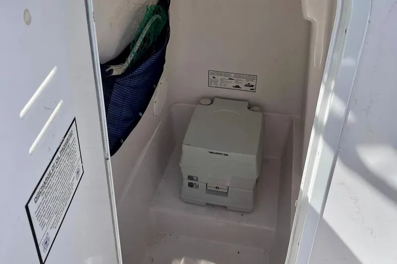 Slide: The Image of Portable toilet inside 2001 Pro-Line 25 Sport CC boat compartment. - 34