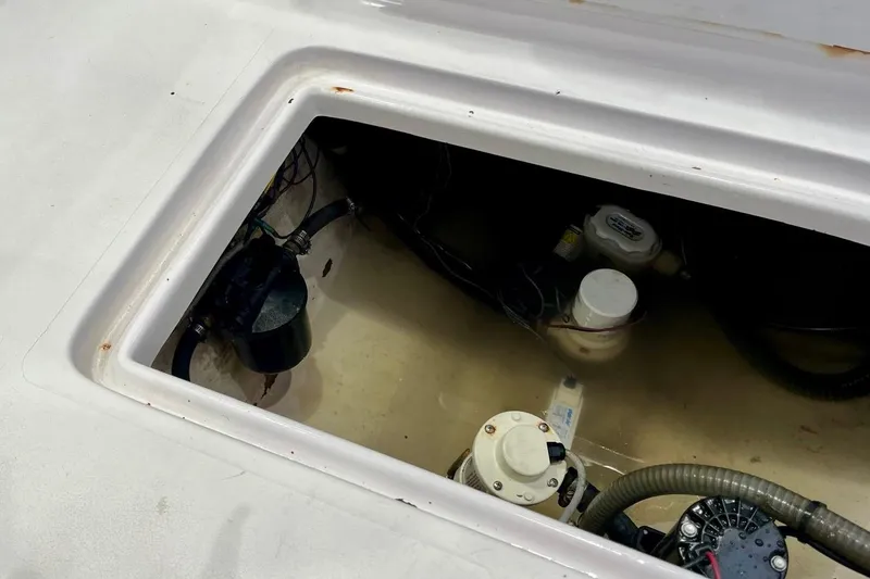 Slide: The Image of 2001 Pro-Line 25 Sport CC boat bilge area with pumps and wiring. - 36