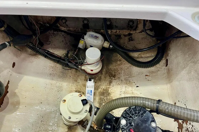 Slide: The Image of 2001 Pro-Line 25 Sport CC bilge area with pumps and wiring. - 37