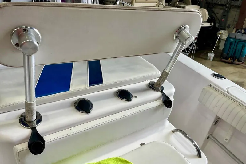Slide: The Image of 2001 Pro-Line 25 Sport CC boat interior with white seating and blue accents. - 9