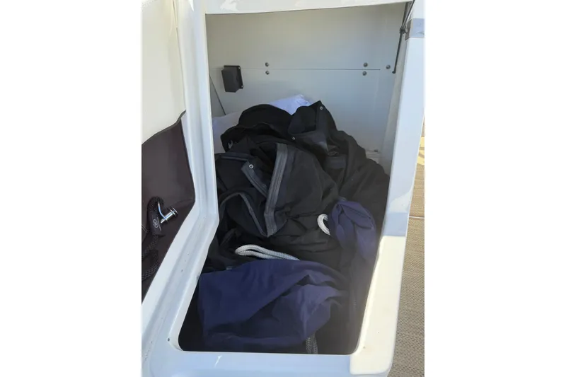 Slide: The Image of Storage compartment of 2020 Cobalt 25SC boat with ropes and jackets inside. - 11