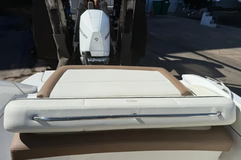 Slide: The Image of 2020 Cobalt 25SC boat with Mercury outboard engine, featuring a cushioned sunpad. - 19