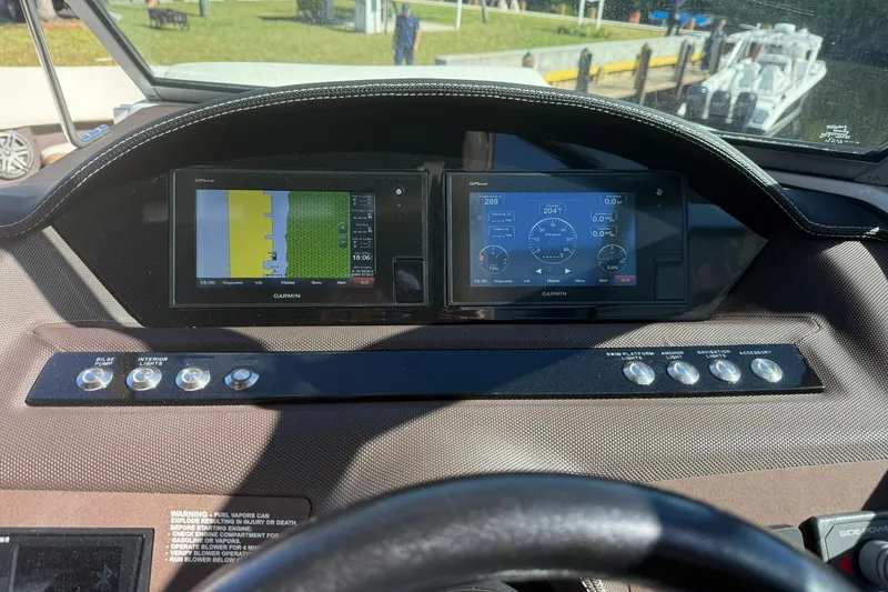 Slide: The Image of Dashboard of 2020 Cobalt 25SC boat with Garmin navigation displays. - 2