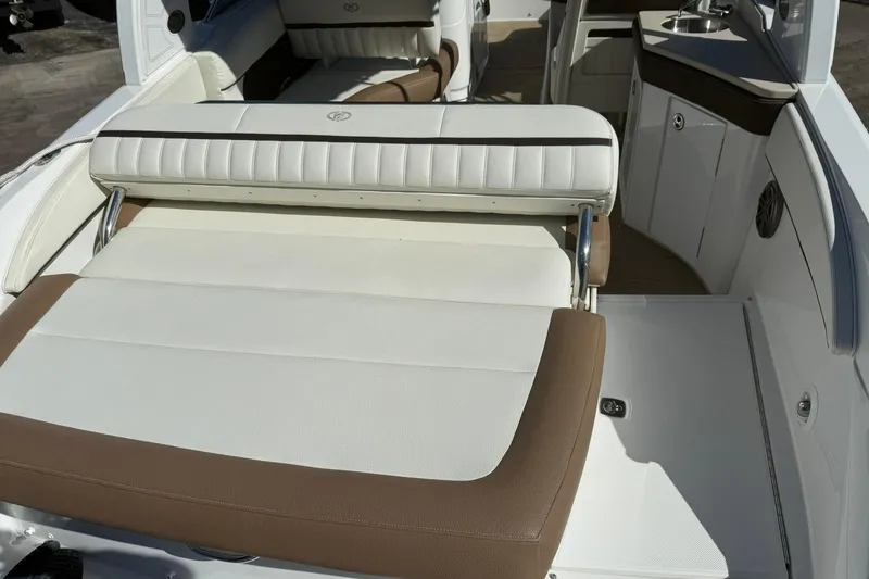 Slide: The Image of 2020 Cobalt 25SC boat interior with white and brown seating and sleek design. - 20