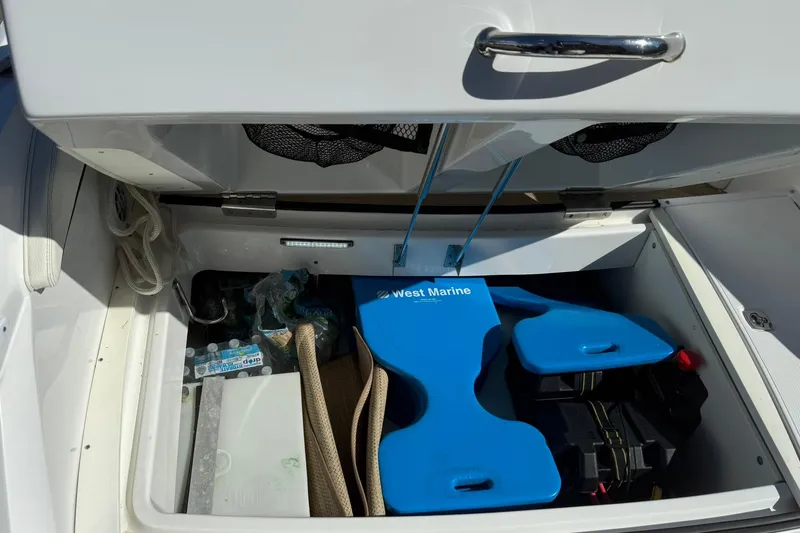 Slide: The Image of Storage compartment of a 2020 Cobalt 25SC boat with marine equipment and supplies. - 24
