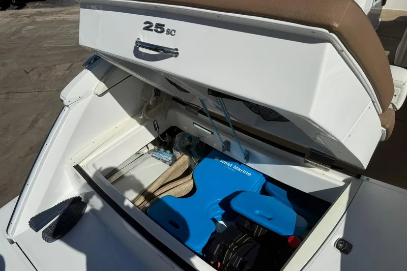 Slide: The Image of 2020 Cobalt 25SC boat storage compartment with marine equipment and accessories. - 25