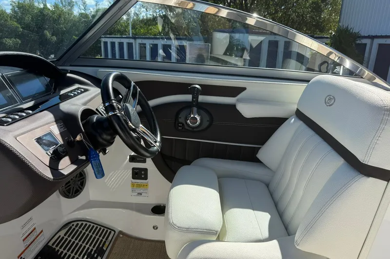 Slide: The Image of Interior of a 2020 Cobalt 25SC boat featuring a sleek steering wheel and plush seating. - 3