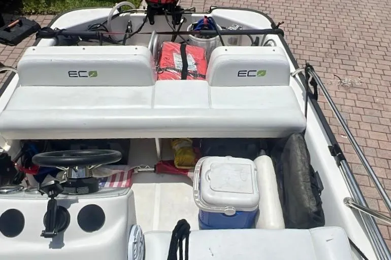 Slide: The Image of 2006 Boston Whaler 130 Sport boat interior with seating and storage compartments. - 3