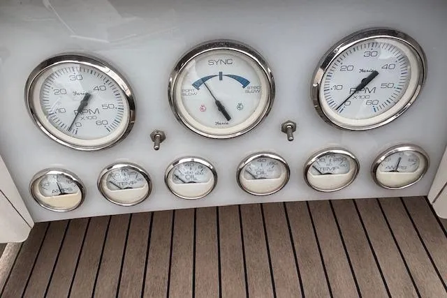 Slide: The Image of 1964 Pacemaker 36 Sportfisherman helm with wooden dashboard and chrome steering wheel. - 12