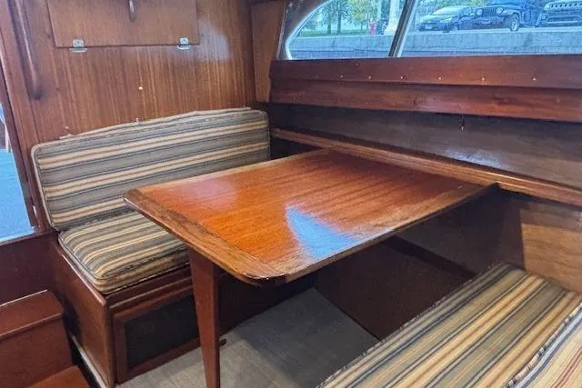 Slide: The Image of 1964 Pacemaker 36 Sportfisherman boat deck with wooden flooring and seating. - 15