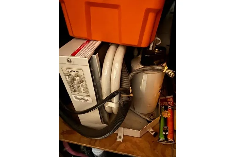 Slide: The Image of 1964 Pacemaker 36 Sportfisherman interior with wooden table and striped cushioned seating. - 16