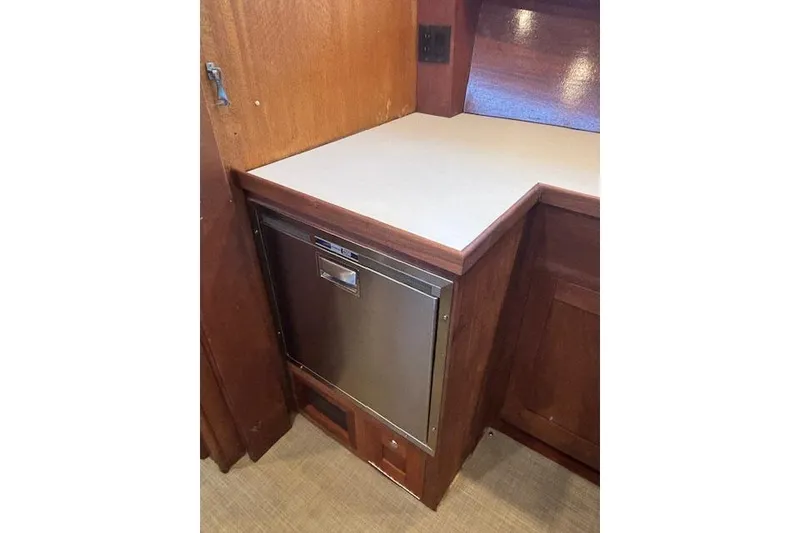 Slide: The Image of 1964 Pacemaker 36 Sportfisherman interior with wooden table and striped cushioned seating. - 21