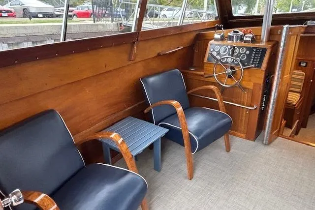 Slide: The Image of 1964 Pacemaker 36 Sportfisherman helm with gauges, controls, and wooden finish. - 24