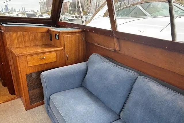 Slide: The Image of Interior of 1964 Pacemaker 36 Sportfisherman with blue sofa and wooden cabinetry. - 25