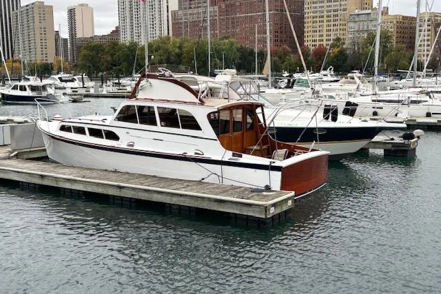 Slide: The Image of 1964 Pacemaker 36 Sportfisherman boat docked in urban marina with city skyline. - 4