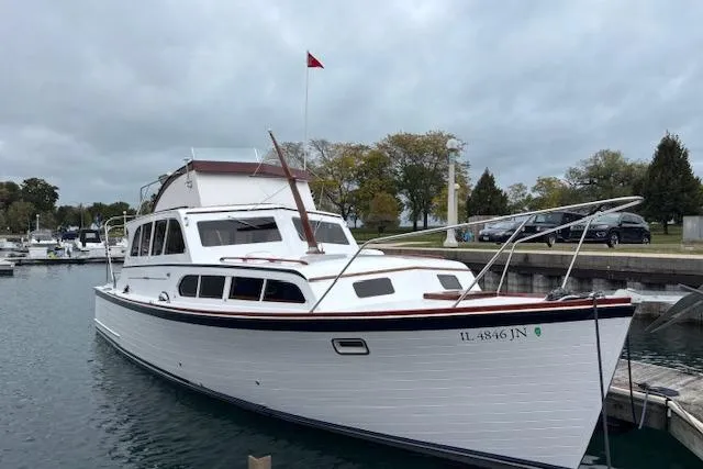 Slide: The Image of 1964 Pacemaker 36 Sportfisherman boat docked in a marina under cloudy skies. - 8
