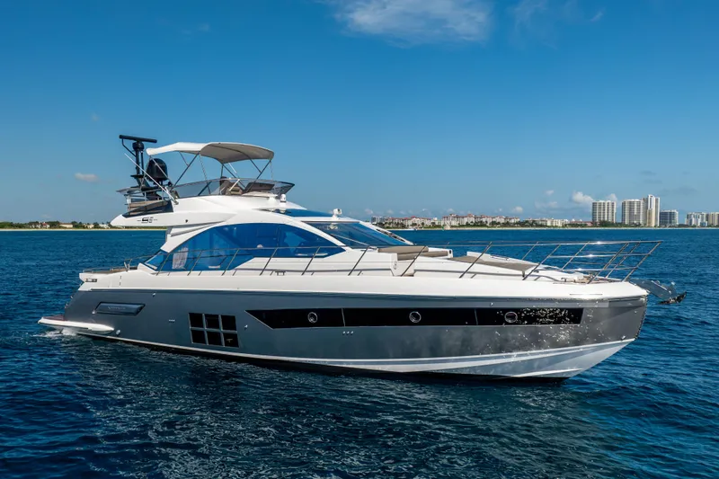 The Image of 2021 Azimut S6 Sportfly yacht cruising on open water under clear blue sky. - 0