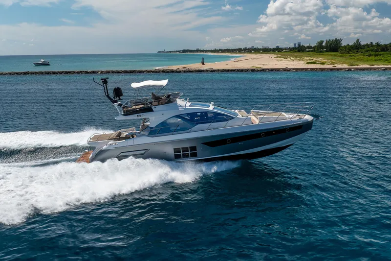 Slide: The Image of 2021 Azimut S6 Sportfly yacht cruising on blue ocean near sandy coastline. - 11
