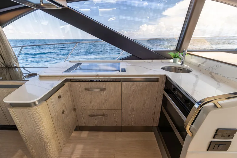 Slide: The Image of Luxurious interior of 2021 Azimut S6 Sportfly yacht with modern kitchen and helm. - 110