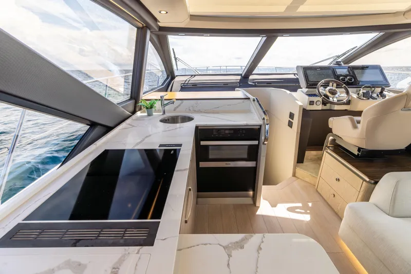 Slide: The Image of Luxurious interior of 2021 Azimut S6 Sportfly yacht with modern helm and kitchen area. - 111
