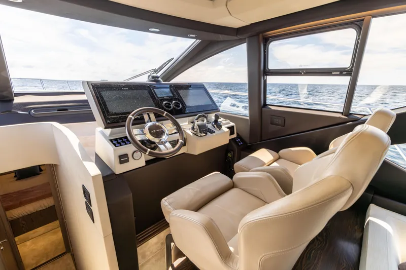 Slide: The Image of 2021 Azimut S6 Sportfly helm with advanced navigation systems and luxurious seating, overlooking the ocean. - 119