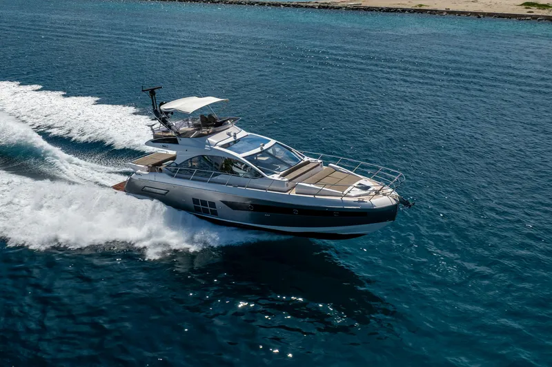 Slide: The Image of 2021 Azimut S6 Sportfly yacht cruising on clear blue water. - 13