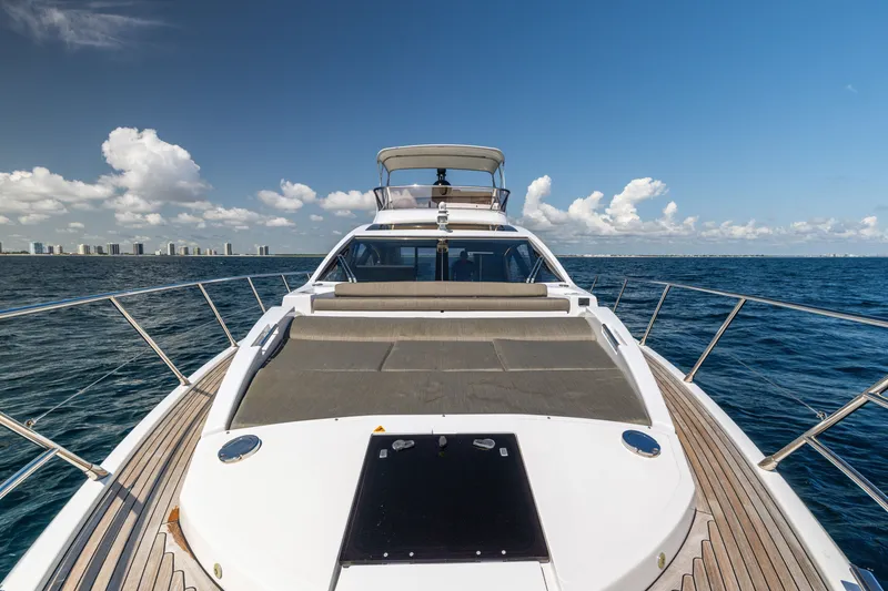 Slide: The Image of 2021 Azimut S6 Sportfly yacht with spacious deck, cruising on open water under clear skies. - 131