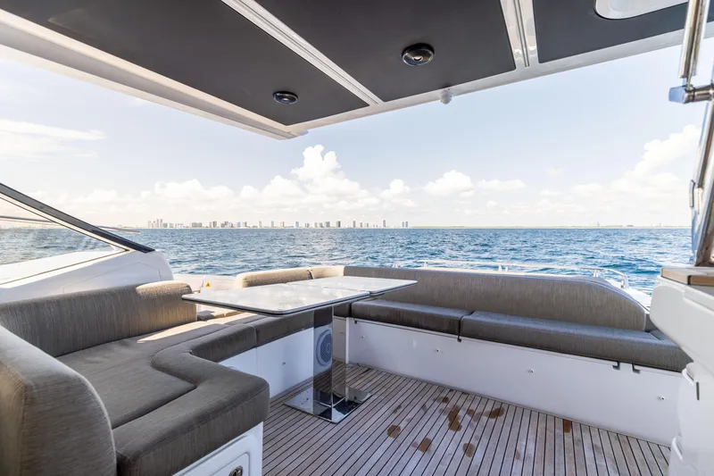 Slide: The Image of Luxurious 2021 Azimut S6 Sportfly yacht deck with seating, overlooking ocean and city skyline. - 140