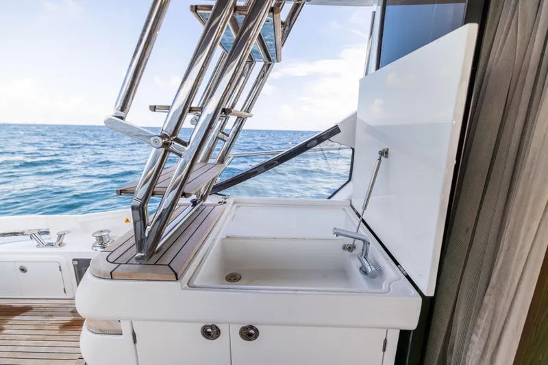 Slide: The Image of Azimut S6 Sportfly 2021 yacht deck with open storage and ocean view. - 161