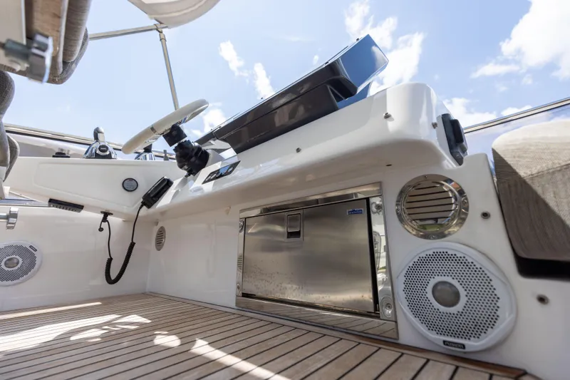 Slide: The Image of 2021 Azimut S6 Sportfly yacht docked, showcasing rear deck and open storage compartment. - 184