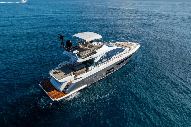 Slide: The Image of 2021 Azimut S6 Sportfly yacht cruising on open sea under clear blue sky. - 22